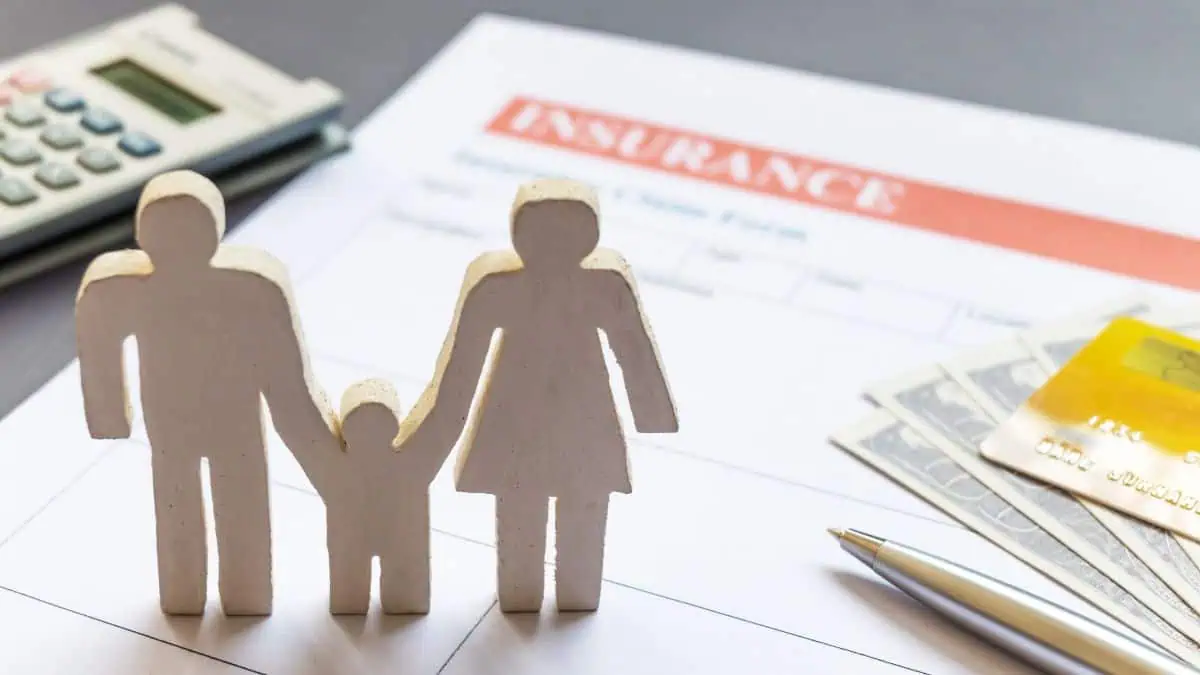 A photo of a family cut out placed on top of an insurance related document