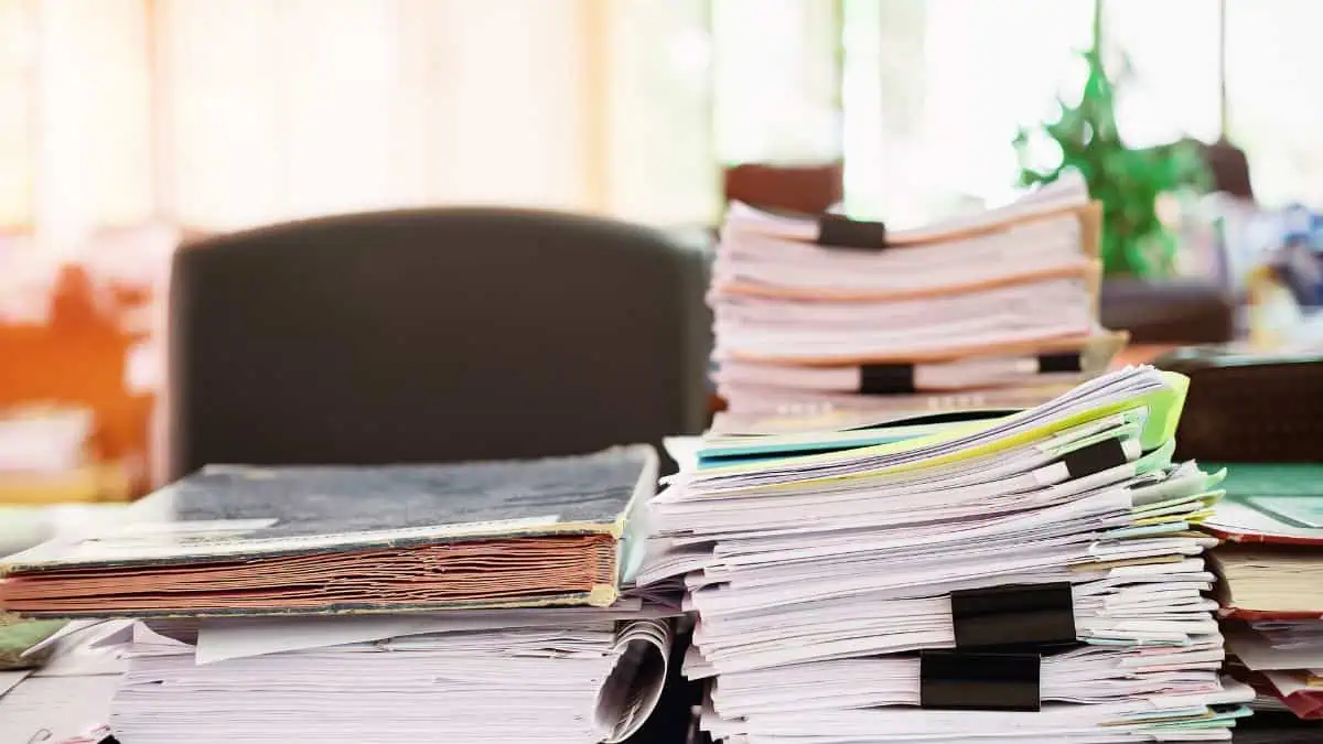 A desk piled up with documents